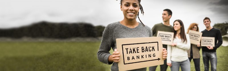 People holding signs that say Take Back Banking